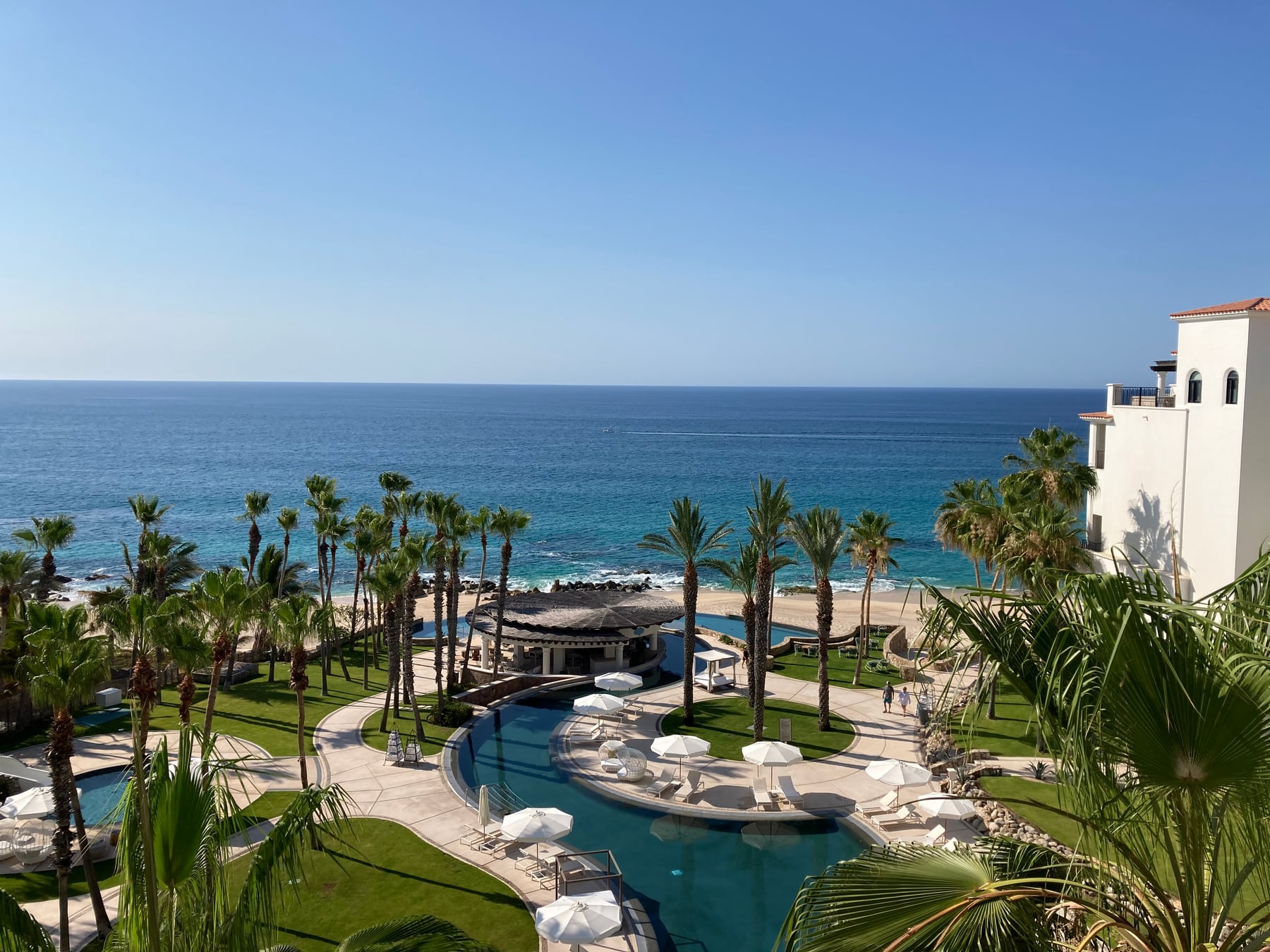 Resort pools, palm trees and ocean at Hilton Los Cabos along the Tourist Corridor.