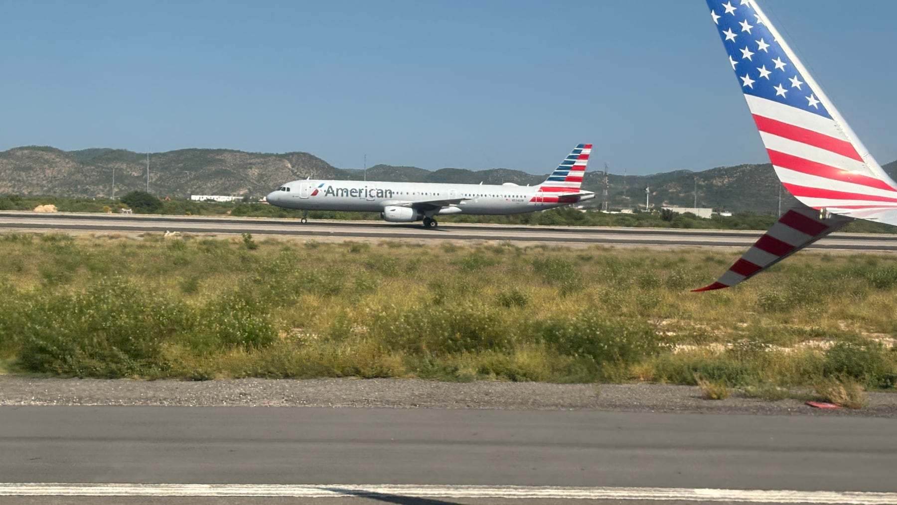 Commercial aircraft parked at Los Cabos International Airport under clear skies.